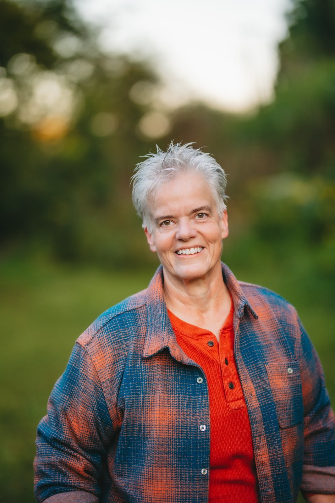 Deana Coble smiling outdoors in her plaid shirt